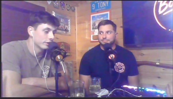 The show's first special guest and Anthony talking at their podcast microphones