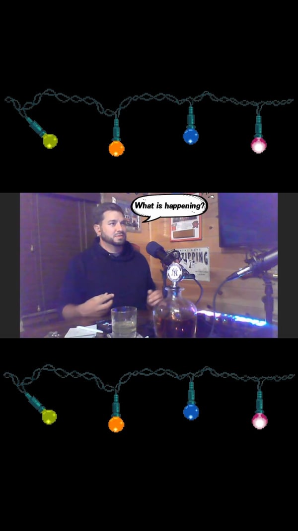 Anthony at the podcast microphone, framed by colorful Christmas lights